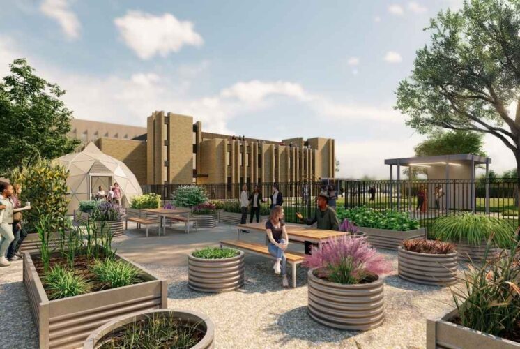 Guests enjoy the outdoor garden area at Kintsugi Village in Detroit during the grand opening celebration with art, food, and family fun.