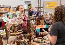 Shoppers browse handmade crafts, art, and jewelry at the Michigan Makers Market at The Hawk in Farmington Hills.