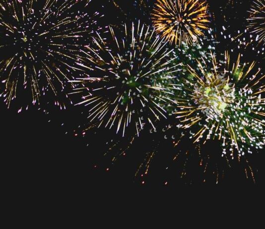 Family-Friendly Noon Year’s Eve Party at Henry Ford Museum of American Innovation Noon Year's Eve fireworks celebration for families and kids with bright bursts in the night sky at a family-friendly event