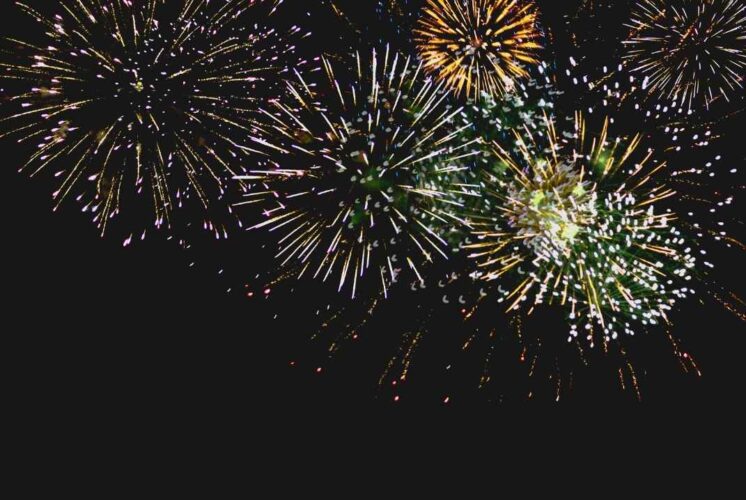 Noon Year's Eve fireworks celebration for families and kids with bright bursts in the night sky at a family-friendly event