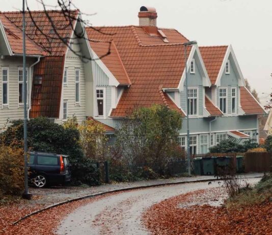 Annual Fall Open House in Shelby Township Cars and visitors line a neighborhood near the Packard Proving Grounds Fall Open House in Shelby Township surrounded by autumn leaves.