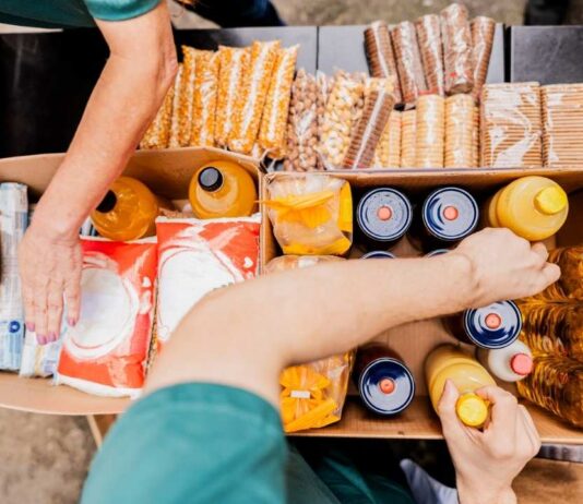 Volunteers sort food and drinks for Rockin for the Hungry at Westgate Kroger supporting families in need during the community fundraiser