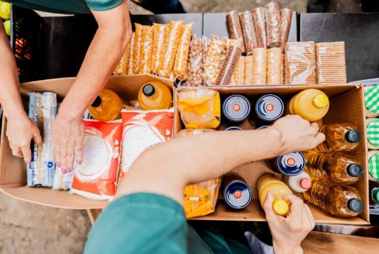 Volunteers sort food and drinks for Rockin for the Hungry at Westgate Kroger supporting families in need during the community fundraiser
