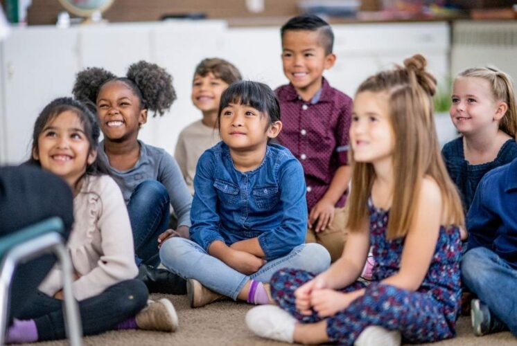Kids sit together during storytime at Greenmead Historical Park for the Stories, Snacks and Crafts event in Livonia.