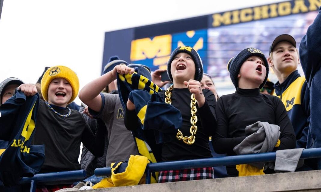 Young Michigan Wolverines fans cheer from the stands during a University of Michigan football spring game at the Big House in Ann Arbor.