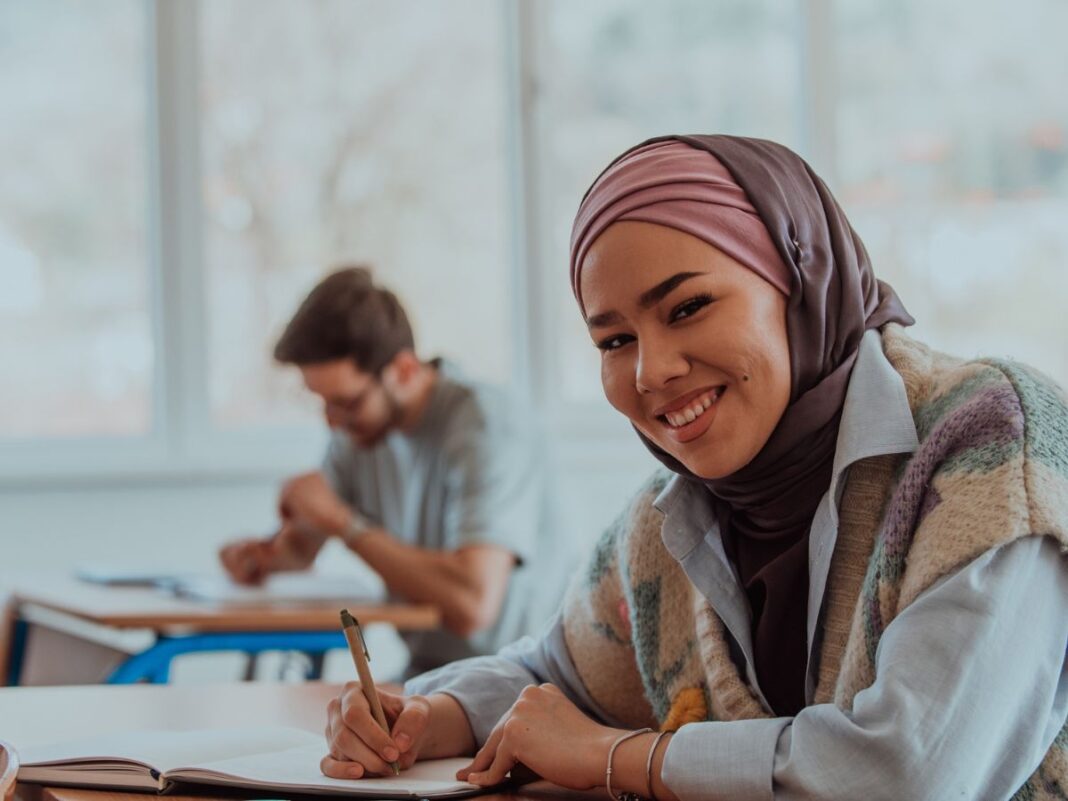 Wayne County Community College District student smiling confidently while studying in class