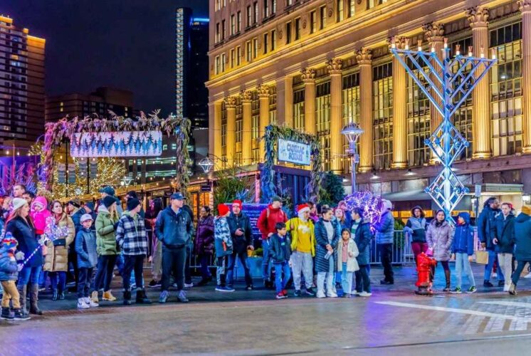 Families gather at Campus Martius Park in downtown Detroit during the annual Detroit Tree Lighting holiday celebration.
