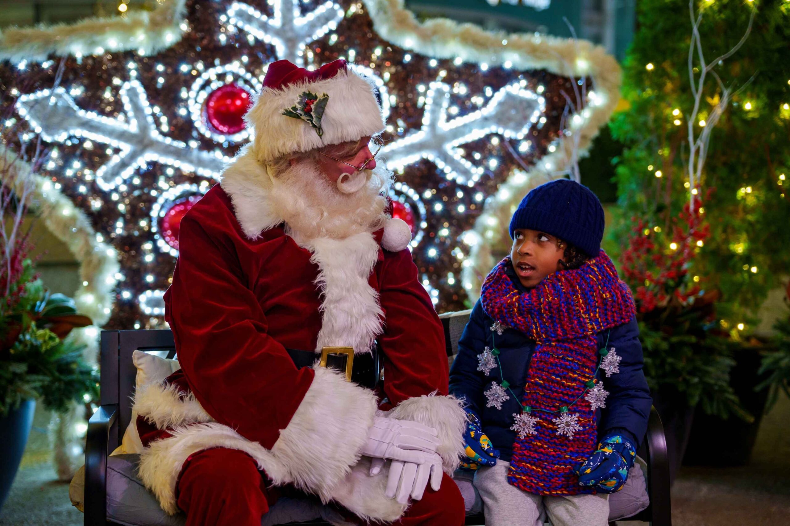 Santa talks with a young child during the Downtown Detroit Tree Lighting at Campus Martius Park, part of the city’s holiday celebration.