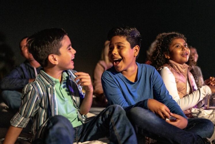 Kids laughing and watching a live performance related to Dont Let Pigeon Drive the Bus at Trenton Village Theatre during the family show.