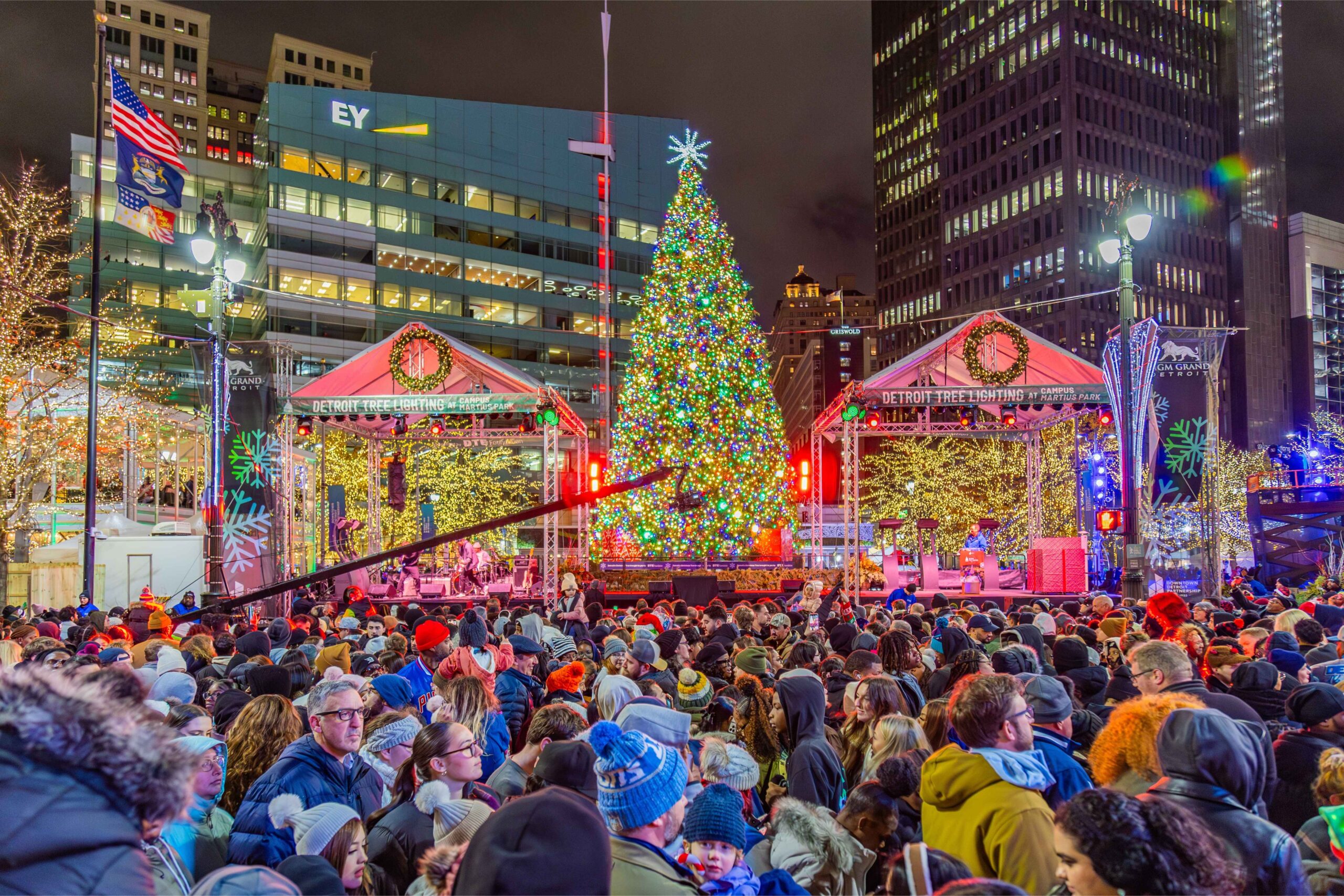 A large crowd gathers for the Downtown Detroit Tree Lighting at Campus Martius Park as the city’s holiday tree glows with colorful lights.