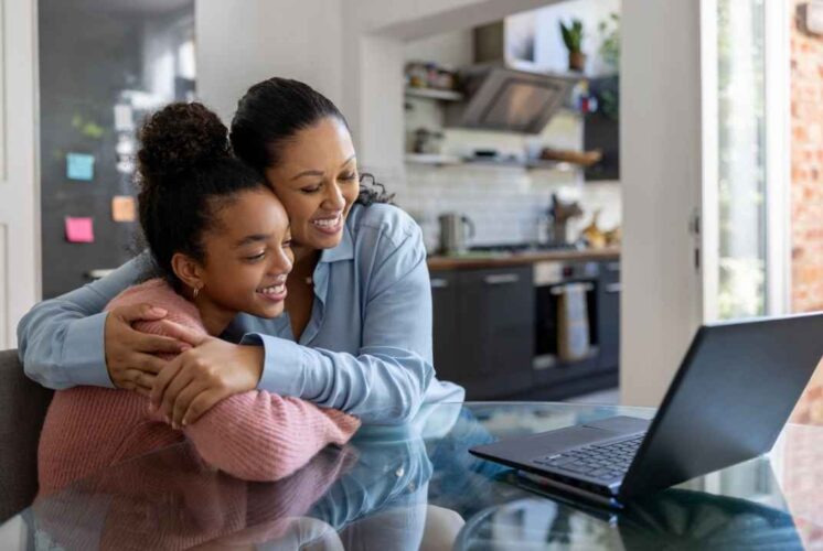 A parent and student smile while attending a virtual Early College Alliance Shadow Day at EMU to learn about high school and college opportunities.
