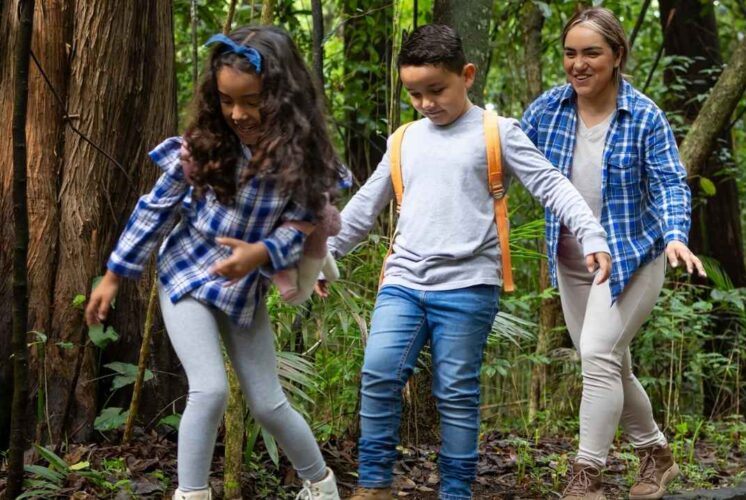 A family with young kids enjoys the Family Nature Hike at Stony Creek Metropark exploring nature trails and learning about wildlife.