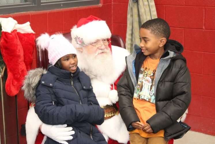 Santa visiting with kids during the Holiday lights ceremony in Farmington Hills with a kid friendly meet and greet atmosphere