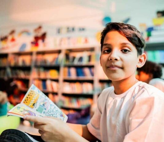 A child reads a comic book during the Kids Comic Class at Northfield Township Area Library where kids learn to create their own characters.