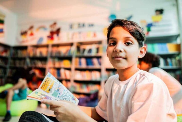 A child reads a comic book during the Kids Comic Class at Northfield Township Area Library where kids learn to create their own characters.