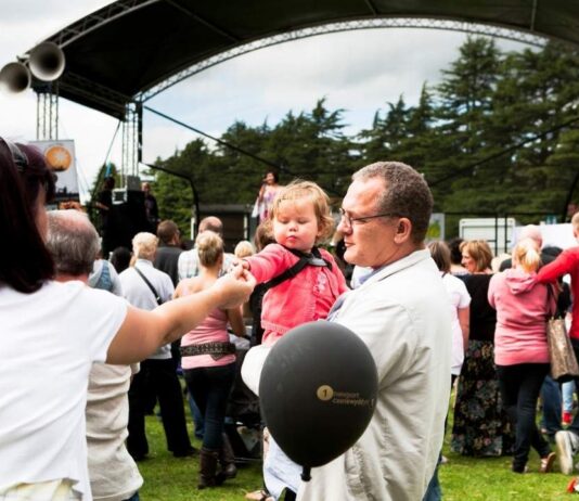 DJ Whittingtons Kool Kat Hip Hop Panto at Theatre Nova Families gather outdoors near a stage during the Kool Kat Hip Hop Panto at Theatre Nova enjoying live entertainment together