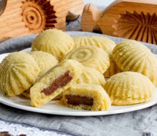 Plate of ma’amoul date cookies with wooden molds displayed for the Make a Date Cookie event at Huntington Woods Public Library.