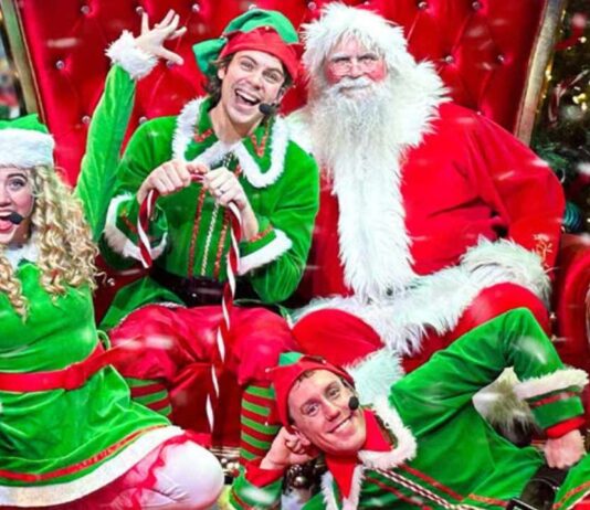 Santa and His Elves Show at Fairytale Fun Place Santa and his elves pose together in festive costumes during the Santa and His Elves show at Fairytale Fun Place creating a joyful holiday moment