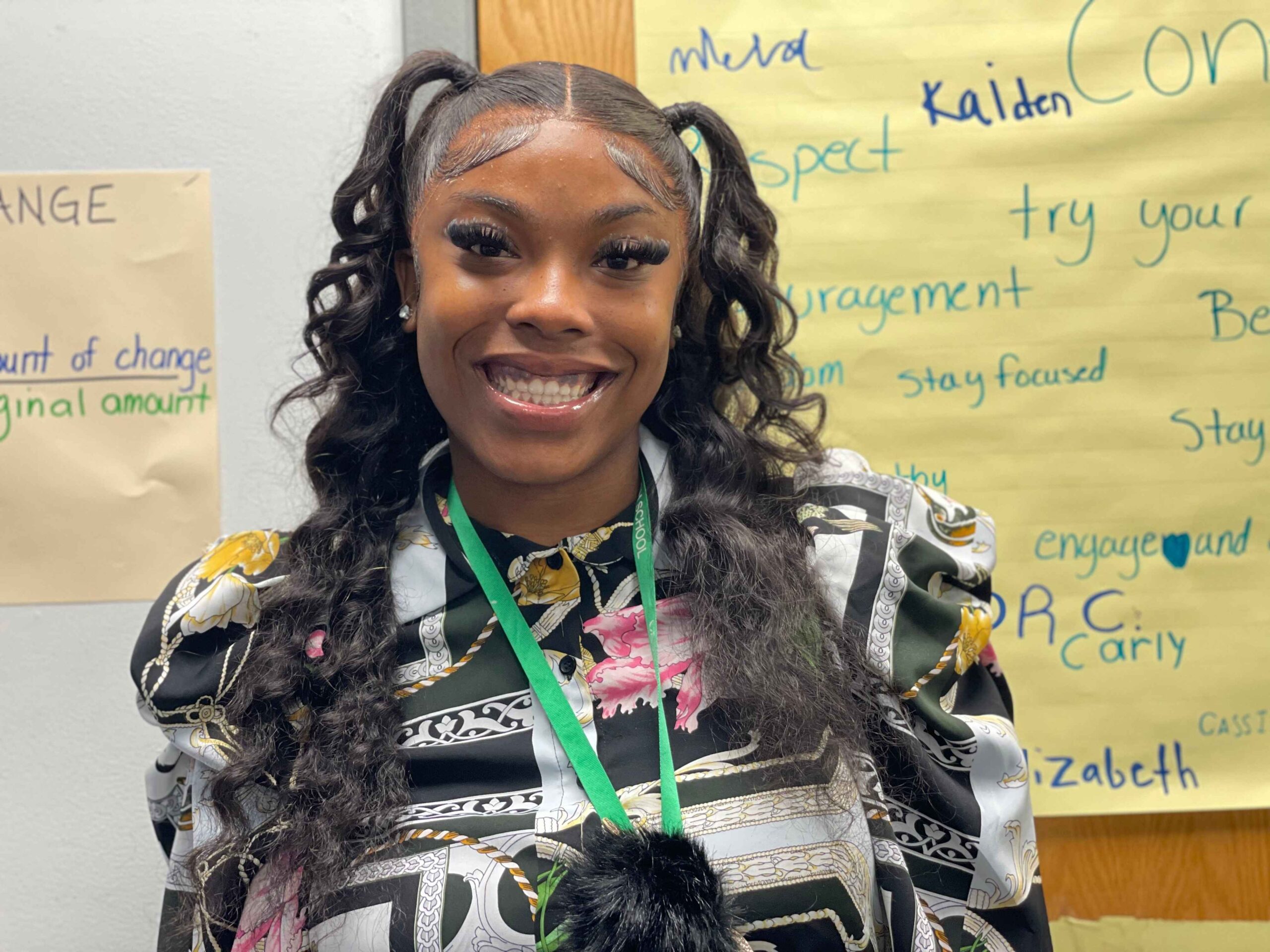 Shauna Jackson, middle school math teacher and Metro Charter Academy alum, standing in front of a classroom display in Romulus, Michigan.