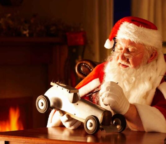 Soulful Santa workshop and holiday market Soulful Santa workshop holiday market scene with Santa working on a toy car by the fire capturing the warm holiday spirit of the event