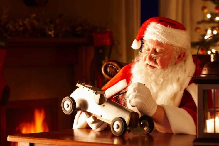 Soulful Santa workshop holiday market scene with Santa working on a toy car by the fire capturing the warm holiday spirit of the event