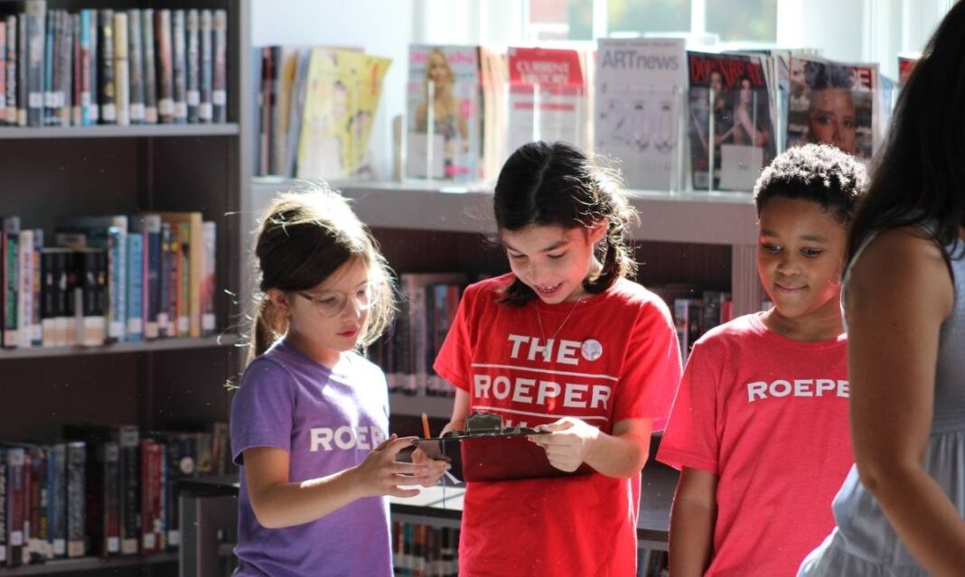 Elementary students at The Roeper School collaborate in the library, showcasing curiosity and community in gifted education learning.