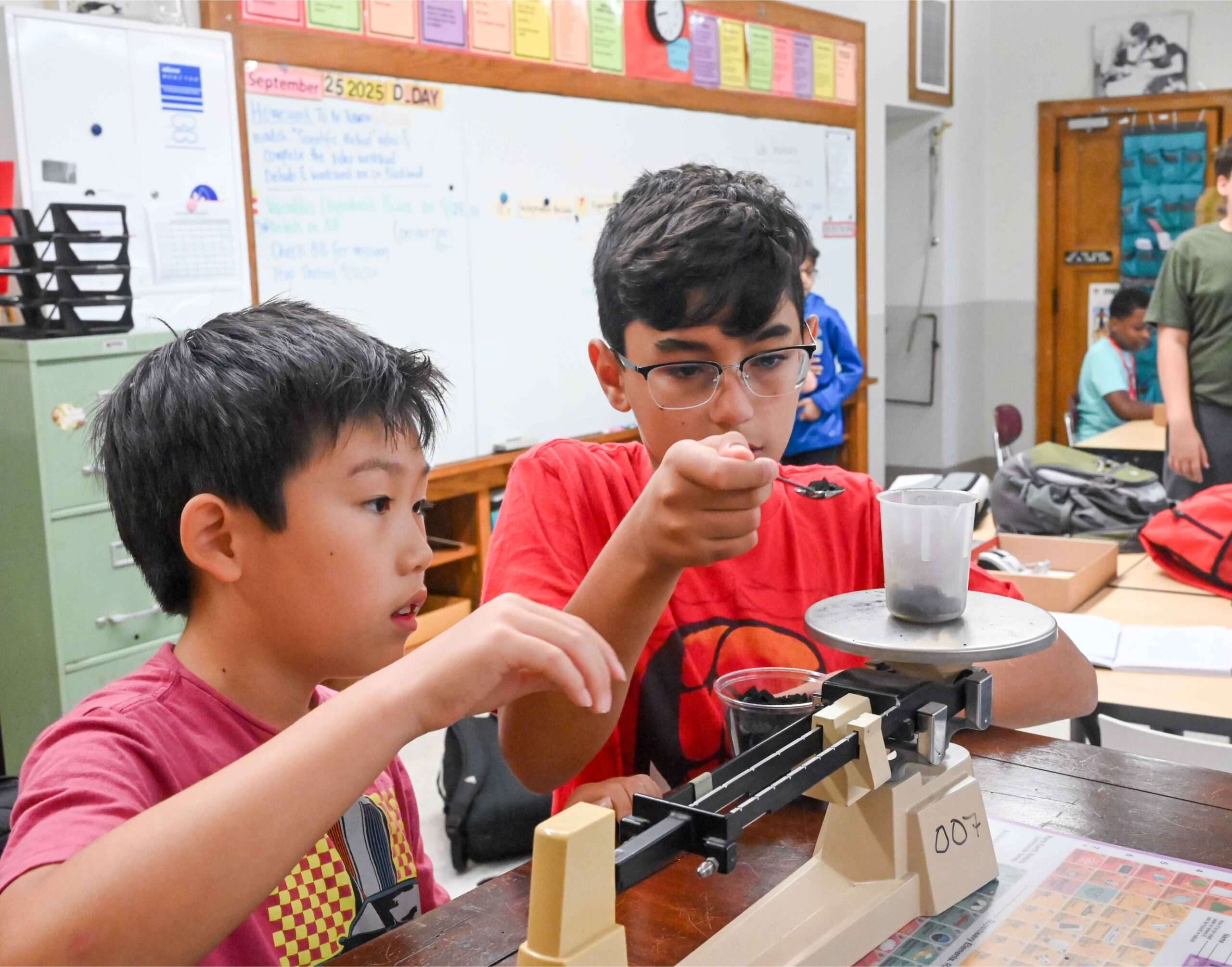Two middle school students at The Roeper School conduct a hands-on science experiment, reflecting the school’s gifted education approach.