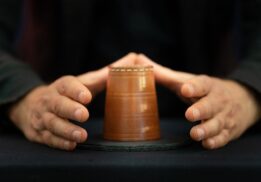 Magician performs a classic cup trick during the A2 magic show at Ann Arbor Hands On Museum as part of a fun family performance