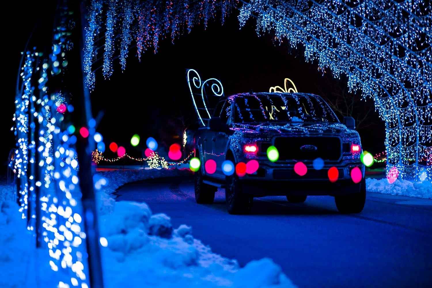 A car drives through the Christmas Lite Show in Grand Rapids, one of Michigan’s drive-through Christmas lights beyond metro Detroit.