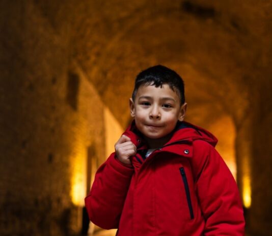 Dig with Spinning Dot Theater at Ann Arbor Hands On Museum Child explores a tunnel like space during Dig with Spinning Dot Theater at Ann Arbor Hands On Museum, an interactive storytelling performance for kids