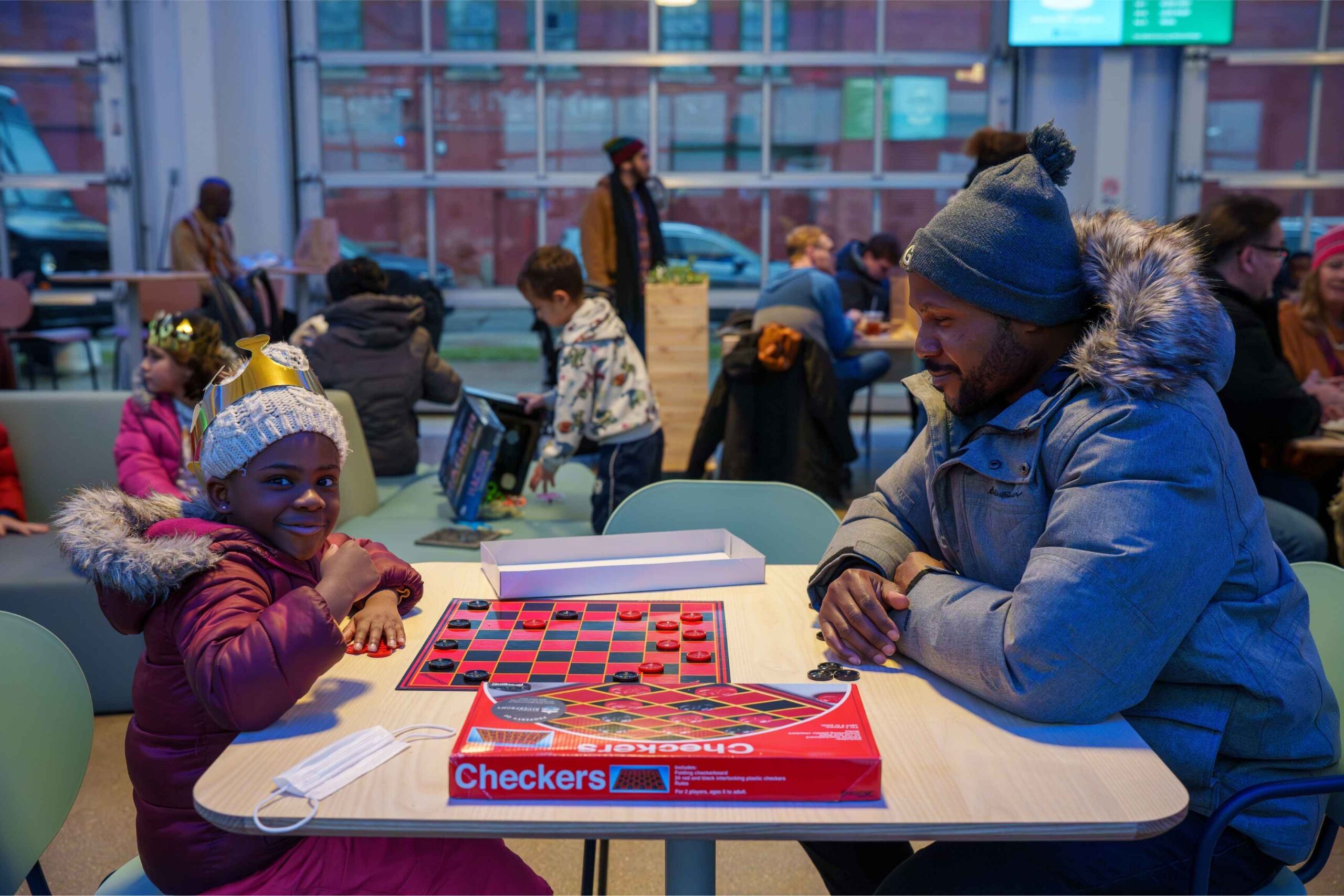 Family plays board games during the Hyde Park Art Center MLK Day celebration featuring free all-ages activities and community fun