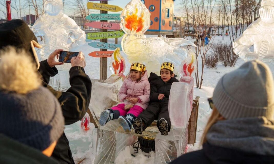 Families enjoy a Hyde Park Art Center MLK Day celebration as children pose on an ice sculpture during the free all-ages event
