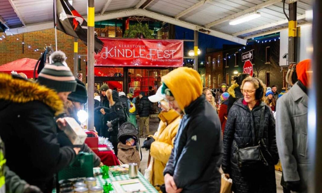 Shoppers browsing holiday booths at Kerrytown KindleFest in Ann Arbor during a festive outdoor market event