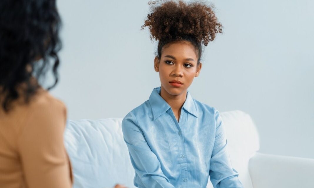 Peer recovery coach meeting with a woman during a support session in a metro Detroit counseling setting