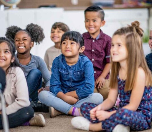 Children sit together listening during a storytime activity similar to Stories Snacks and Crafts at Greenmead Historical Park for ages 4 to 10