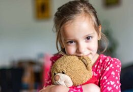 Child hugging a stuffed animal during the Stuff A Pet event where kids adopt and take home a plush toy at a family activity