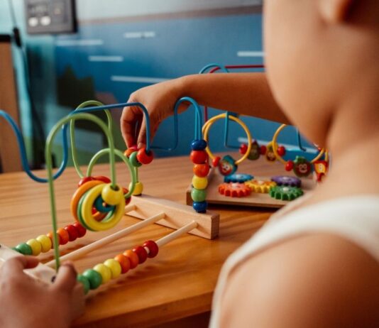 Discover and Play Family Fest at HYPE Athletics Discover and Play Family Fest early learning activity showing a young child building motor skills with a hands on play station