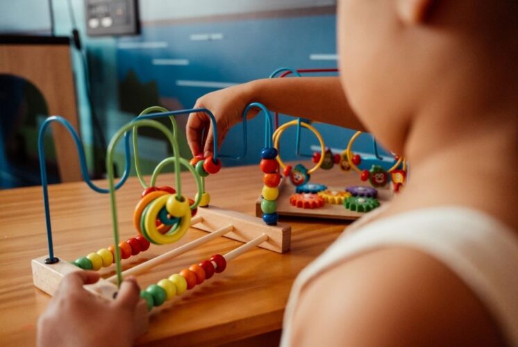 Discover and Play Family Fest early learning activity showing a young child building motor skills with a hands on play station