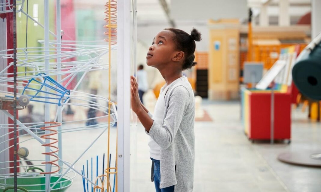 Girl exploring hands-on science exhibits during Discovery Days Women and Girls in Science at Cranbrook Institute of Science