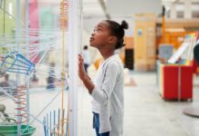 Girl exploring hands-on science exhibits during Discovery Days Women and Girls in Science at Cranbrook Institute of Science