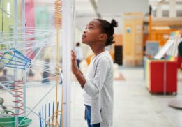 Girl exploring hands-on science exhibits during Discovery Days Women and Girls in Science at Cranbrook Institute of Science