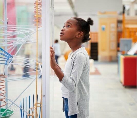 Discovery Days Women and Girls in Science at Cranbrook Institute of Science Girl exploring hands-on science exhibits during Discovery Days Women and Girls in Science at Cranbrook Institute of Science