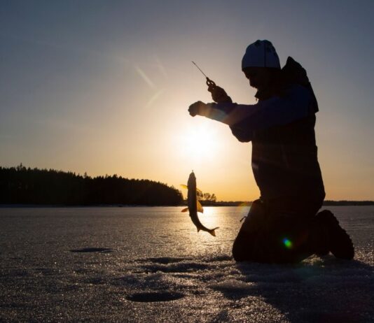 Outdoorama at Vibe Credit Union Showplace Child ice fishing at Ice Fishing Derby Independence Lake during a winter family event with kid and adult fishing divisions