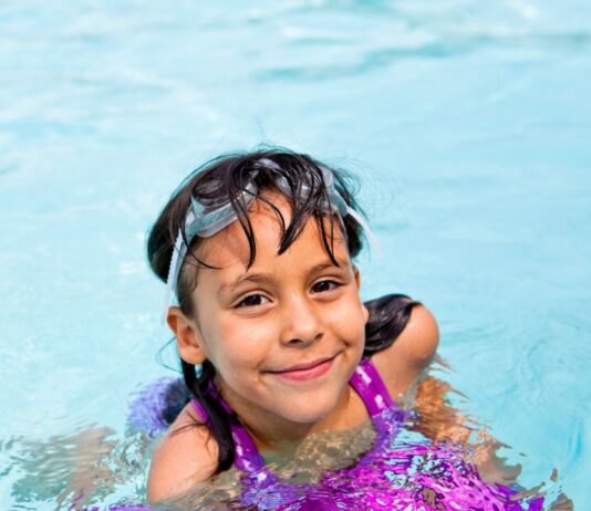 Kiddie Swim at Troy Community Center Smiling child enjoys Kiddie Swim at Troy Community Center during a shallow pool swim time designed for young kids ages 6 and under