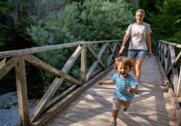 Young child exploring nature with a caregiver during the Morning Munchkins nature program at Red Oaks Nature Center for preschool kids.