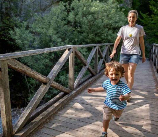 E-Recycling at Detroit Zoo 10 Mile Road parking lot Young child exploring nature with a caregiver during the Morning Munchkins nature program at Red Oaks Nature Center for preschool kids.