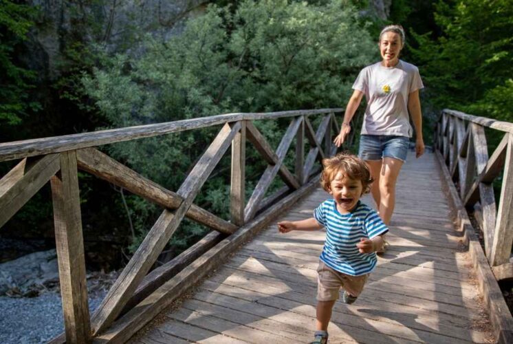Young child exploring nature with a caregiver during the Morning Munchkins nature program at Red Oaks Nature Center for preschool kids.
