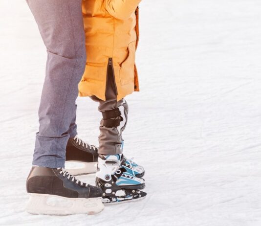 Shadow Night at Dodge Park Ice Rink Adult and child enjoy open ice skating at Stine Community Park during a family friendly outdoor skating session in winter