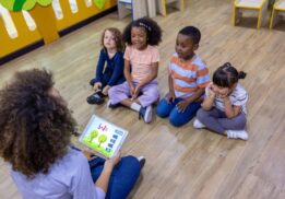 Preschool children taking part in PREK Story and STEAM class with a teacher leading hands-on learning and early STEM activities