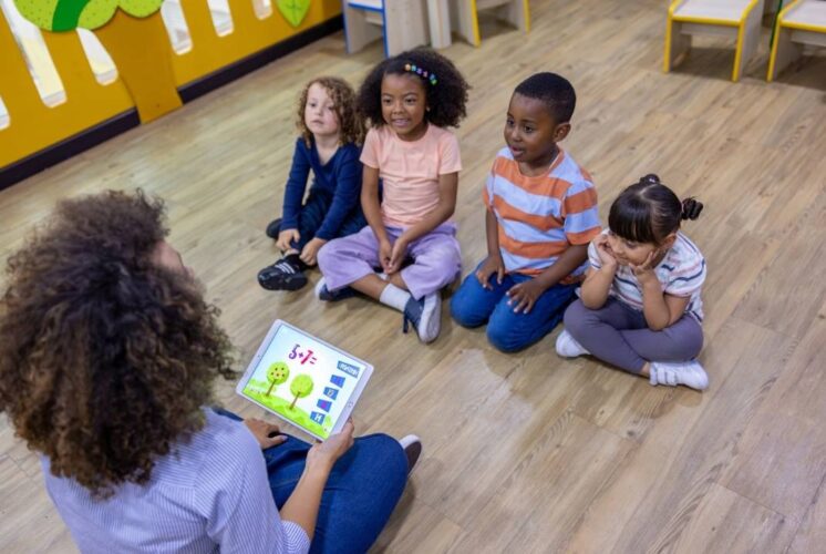 Preschool children taking part in PREK Story and STEAM class with a teacher leading hands-on learning and early STEM activities